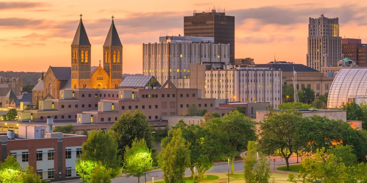 City skyline at sunset with trees.