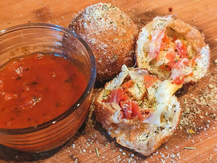 Fried pizza balls with marinara sauce.